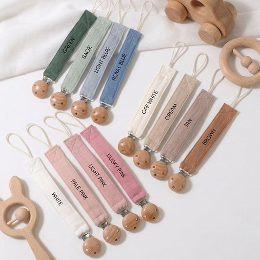 colourful personalised dummy clip for a newborn baby boy or girl with an embroidered name.